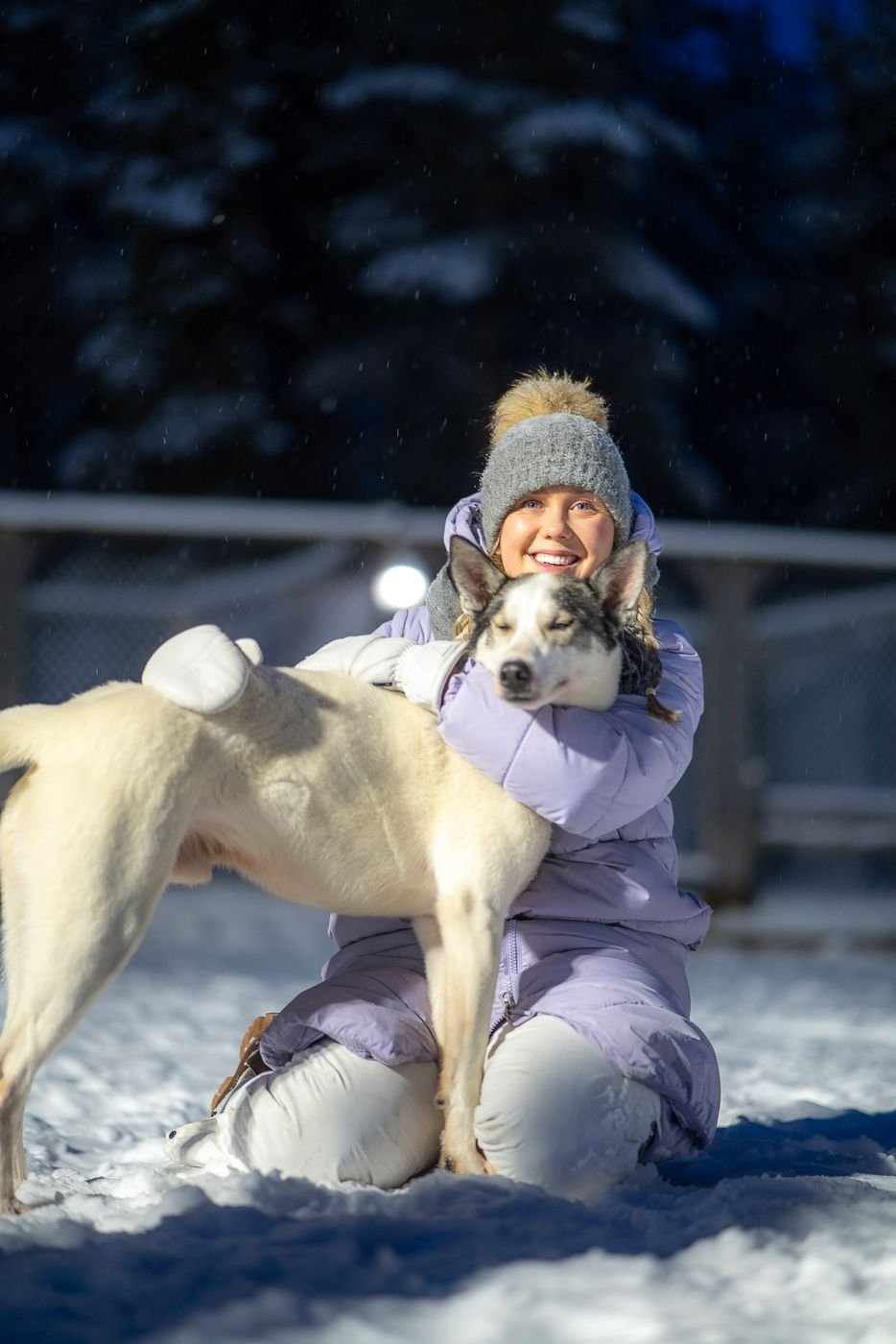 Ida from Lumo Lapland hugging a husky in the snow
