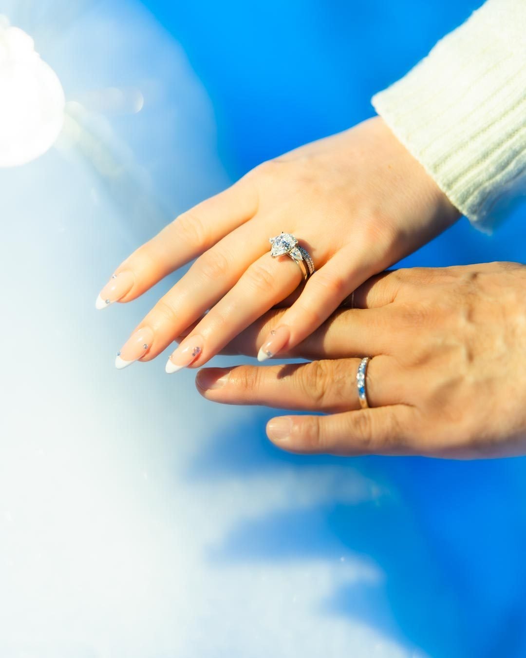 Engagement ring on her hand against the snow in Lapland